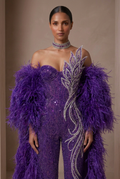 Front close-up of the royal purple couture jumpsuit with sculpted crystals and feather sleeves